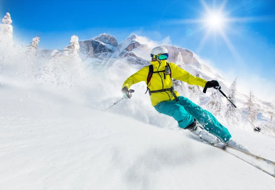 A skier carving through fresh powder